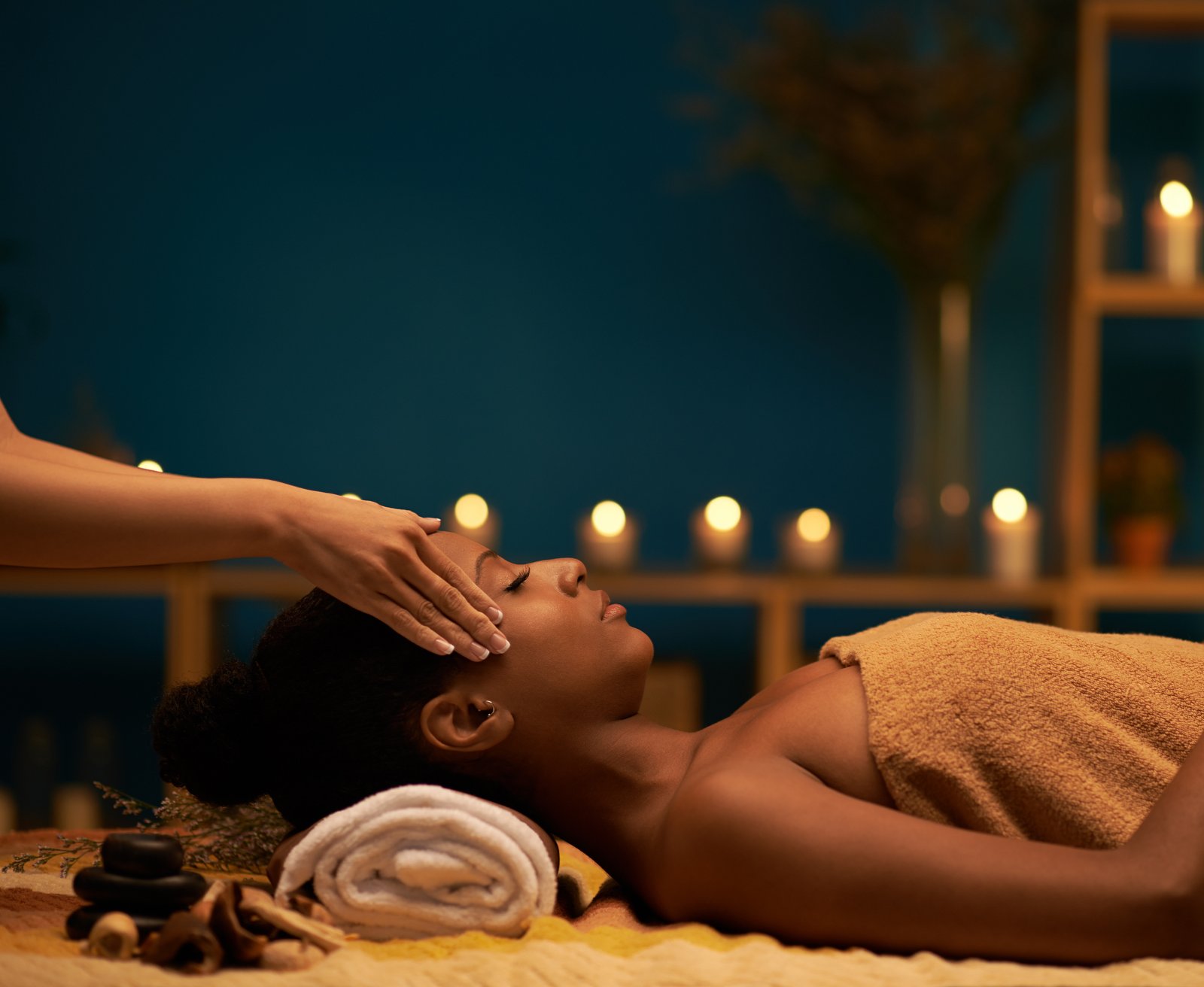 Spa ambiance photo used in the Myers Jackman brand — candlelit massage treatment room